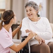 A care professional talking with an older woman at home