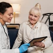 A care professional reviewing information with an older woman