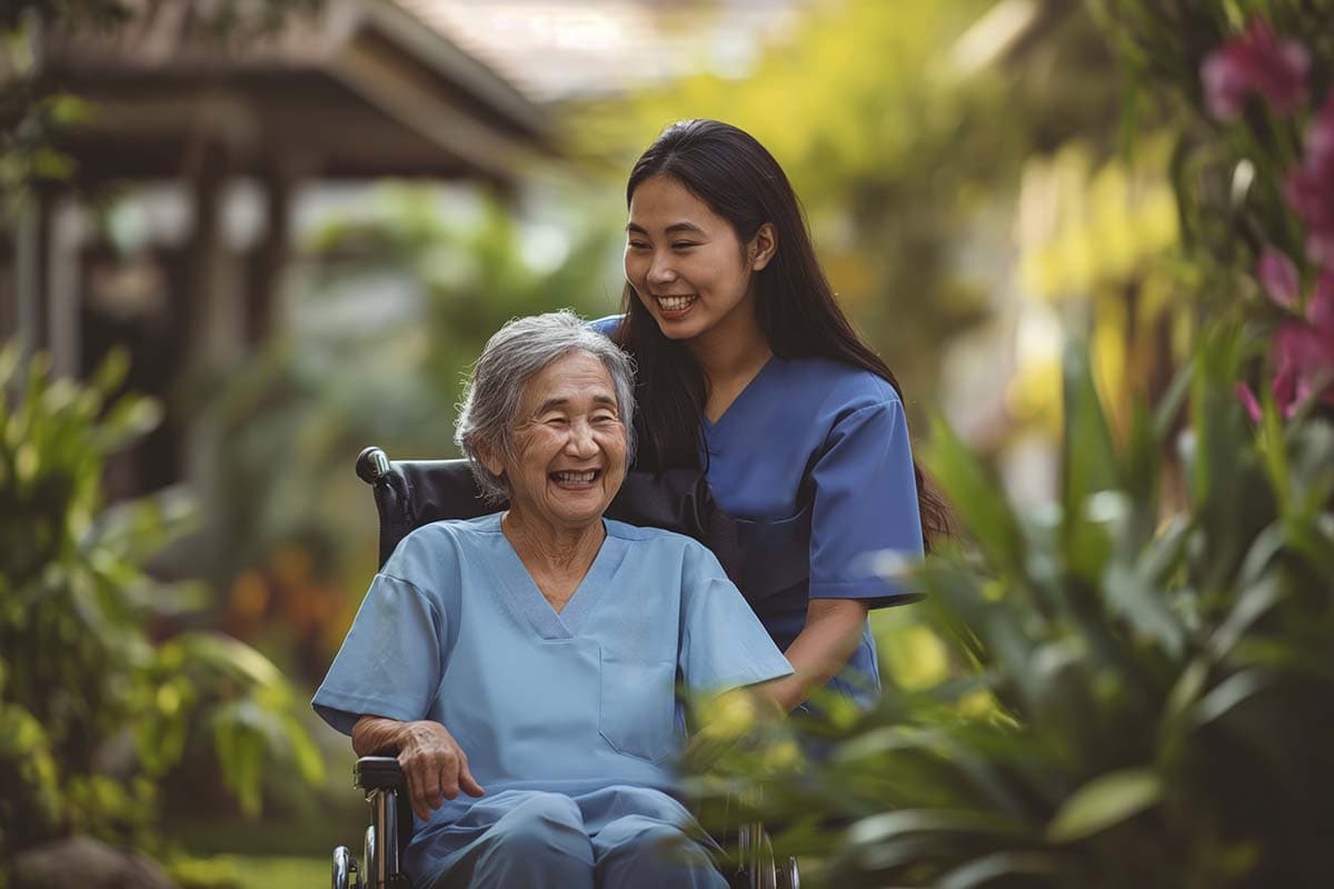 A support worker assisting a wheelchair user outdoors