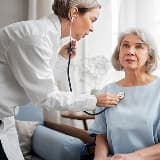 A care professional discussing support with an older woman