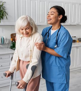 A support worker assisting an older woman at home
